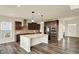 Modern kitchen with a large island, stainless steel appliances, and dark wood cabinets at 10811 Wild Orchard Ln, Indianapolis, IN 46239