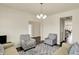 Spacious living room featuring comfortable seating, neutral decor, and a view into the dining area at 10811 Wild Orchard Ln, Indianapolis, IN 46239