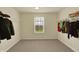 The walk-in closet is spacious with natural light, featuring shelving and hanging space for optimal organization at 10811 Wild Orchard Ln, Indianapolis, IN 46239