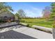 Lovely backyard deck featuring built-in bench seating, privacy screens, and views of the lush green space beyond at 10844 Bentwater Ln, Fishers, IN 46037