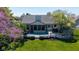 Scenic backyard view highlighting the deck, screened porch, mature trees, and lush landscaping at 10844 Bentwater Ln, Fishers, IN 46037