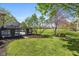 Expansive backyard featuring a large deck, privacy screens, and a lush green lawn, ideal for outdoor enjoyment at 10844 Bentwater Ln, Fishers, IN 46037