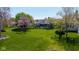 Expansive backyard with mature trees, lush lawn, and a charming screened-in porch offers plenty of room to roam at 10844 Bentwater Ln, Fishers, IN 46037