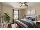 Nicely decorated bedroom with a large window, ceiling fan and hardwood floors at 10844 Bentwater Ln, Fishers, IN 46037