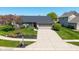 Charming single-story home boasts a well-manicured lawn and a two-car garage, with beautiful landscaping at 10844 Bentwater Ln, Fishers, IN 46037
