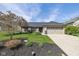 Charming single-story home with well-manicured lawn, black mulch, and attached two-car garage at 10844 Bentwater Ln, Fishers, IN 46037