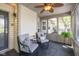 Cozy screened porch with comfortable seating, ceiling fan, and access to a peaceful outdoor living space at 10844 Bentwater Ln, Fishers, IN 46037