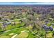 Wide aerial shot of homes surrounded by a golf course, mature trees, and manicured lawns at 11006 Timber Ln, Carmel, IN 46032
