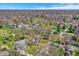 Expansive aerial view showcasing homes in a wooded neighborhood near a golf course at 11006 Timber Ln, Carmel, IN 46032