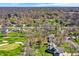 Wide aerial view showing homes and a golf course nestled amongst mature trees and green lawns at 11006 Timber Ln, Carmel, IN 46032