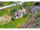 Overhead shot of a house with well-maintained lawn and patio area, framed by mature trees at 11006 Timber Ln, Carmel, IN 46032