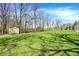Spacious backyard with a storage shed, play set, and a well-maintained lawn surrounded by mature trees at 11006 Timber Ln, Carmel, IN 46032