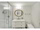 Updated bathroom boasts a glass-enclosed shower, modern vanity, and elegant fixtures at 11006 Timber Ln, Carmel, IN 46032