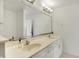 Bright bathroom with double sinks, white cabinets, and large mirror at 11006 Timber Ln, Carmel, IN 46032