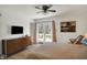Bright bedroom featuring light wood floors, ceiling fan, and sliding glass doors to balcony at 11006 Timber Ln, Carmel, IN 46032