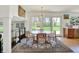 Light-filled dining room with modern chandelier and views of the backyard at 11006 Timber Ln, Carmel, IN 46032