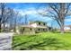 Charming two-story home featuring a well-manicured lawn, mature trees, and a welcoming driveway, creating curb appeal at 11006 Timber Ln, Carmel, IN 46032