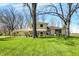 Charming two-story home with yellow siding, landscaped yard, and mature trees at 11006 Timber Ln, Carmel, IN 46032