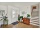 Bright foyer with hardwood floors, white walls, and decorative stairway at 11006 Timber Ln, Carmel, IN 46032