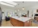 Contemporary kitchen featuring an expansive island, stainless steel appliances, and abundant natural light at 11006 Timber Ln, Carmel, IN 46032