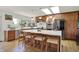 Spacious kitchen boasts an island with seating, stainless steel appliances, and ample natural light from skylights at 11006 Timber Ln, Carmel, IN 46032