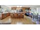 Open concept kitchen with large island, wood cabinets, and hardwood floors at 11006 Timber Ln, Carmel, IN 46032
