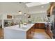 Bright kitchen featuring an expansive island with quartz countertop, modern appliances, and stylish pendant lighting at 11006 Timber Ln, Carmel, IN 46032