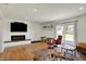 Bright living room features recessed lighting, a modern fireplace, and sliding doors to the backyard at 11006 Timber Ln, Carmel, IN 46032