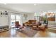 Bright living room features hardwood floors, large windows, and open access to the dining and kitchen areas at 11006 Timber Ln, Carmel, IN 46032