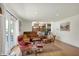 Cozy living room with hardwood floors, comfortable seating, and lots of natural light from windows and doors at 11006 Timber Ln, Carmel, IN 46032