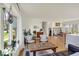 Bright living room with hardwood floors, large windows, and open staircase at 11006 Timber Ln, Carmel, IN 46032
