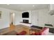 Cozy living room featuring modern fireplace, tv, and hardwood flooring at 11006 Timber Ln, Carmel, IN 46032