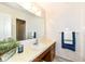 Tidy bathroom featuring a sink, mirror, and white tile, accented with a blue towel at 11359 Peacock Dr, Indianapolis, IN 46236
