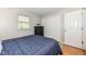 Bright bedroom with warm wood floors, a cozy bed and ample closet space at 11359 Peacock Dr, Indianapolis, IN 46236