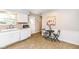 Kitchen featuring white cabinets, vinyl floors, a dining table, and plenty of natural light at 11359 Peacock Dr, Indianapolis, IN 46236