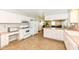 Bright kitchen with white cabinetry, appliances, and durable vinyl flooring at 11359 Peacock Dr, Indianapolis, IN 46236