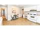 Bright kitchen boasts white cabinets, updated appliances, and a cozy breakfast nook at 11359 Peacock Dr, Indianapolis, IN 46236