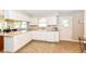 Kitchen with white cabinets, neutral countertops, vinyl flooring, and updated appliances at 11359 Peacock Dr, Indianapolis, IN 46236