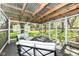 Relaxing sunroom with white furniture and view of the backyard landscape at 11359 Peacock Dr, Indianapolis, IN 46236