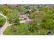 Aerial view of a residence, showcasing its well-manicured lawn, mature trees, and surrounding neighborhood at 11415 Central E Dr, Carmel, IN 46032