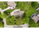 Bird's-eye view of a house featuring a well-kept lawn and mature trees in a serene setting at 11415 Central E Dr, Carmel, IN 46032