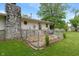 Cozy home backyard featuring a stone fireplace and fenced-in patio area at 11415 Central E Dr, Carmel, IN 46032