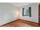 Bright bedroom with hardwood floors, a corner lamp, and a window view at 11415 Central E Dr, Carmel, IN 46032