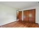 Spacious bedroom featuring wood floors, closet, and access to another room at 11415 Central E Dr, Carmel, IN 46032