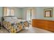 Comfortable bedroom with carpeted floors, light green walls, a floral bedspread, and natural light at 11415 Central E Dr, Carmel, IN 46032