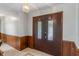 Inviting entryway featuring a dark wood paneled wall and decorative tile flooring at 11415 Central E Dr, Carmel, IN 46032
