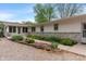 The home's exterior showcases landscaped flowerbeds and a stone facade at 11415 Central E Dr, Carmel, IN 46032