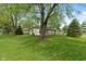 A sprawling ranch-style house with a stone accent wall and a well-maintained green lawn at 11415 Central E Dr, Carmel, IN 46032