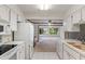 Bright kitchen featuring white cabinets, appliances and plenty of counter space flowing into an open living area at 11415 Central E Dr, Carmel, IN 46032