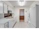Bright kitchen features white appliances, laminate counters, and tiled floor at 11415 Central E Dr, Carmel, IN 46032